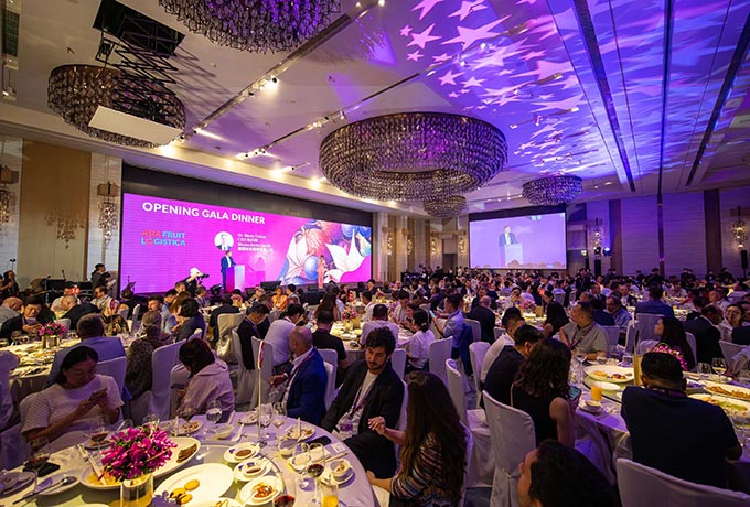 An event hall lighted with purple lights hosts an evening networking event for the Asiafruit Logistica Meet up