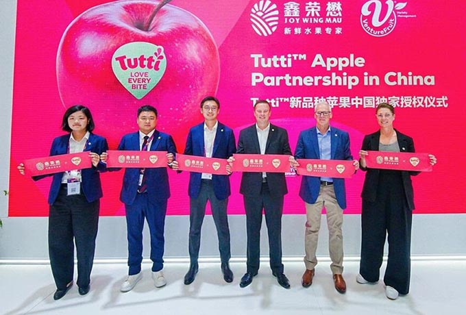 The Joy Wing Mau and VentureFruit teams on the stage announcing the Tutti apple program expansion