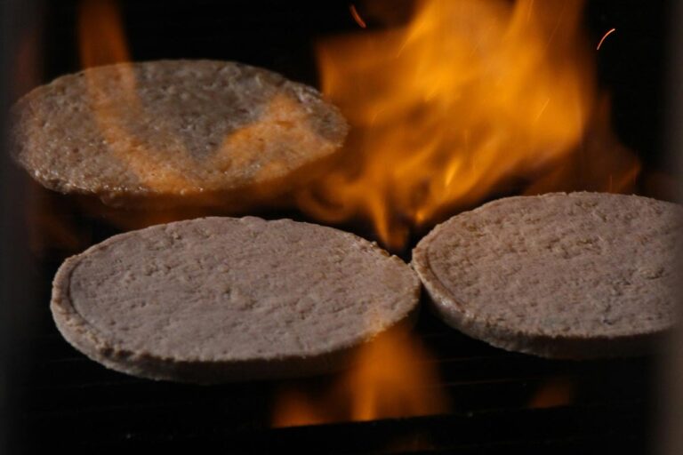 Burgers probably with cherry pulp on a grill
