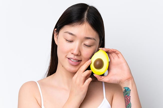 Person holding avocado