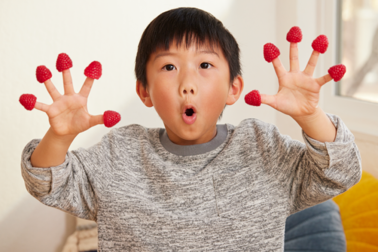 KID WITH BERRIES ON FINGERS