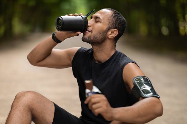 Young man working out and drinking a protein shake